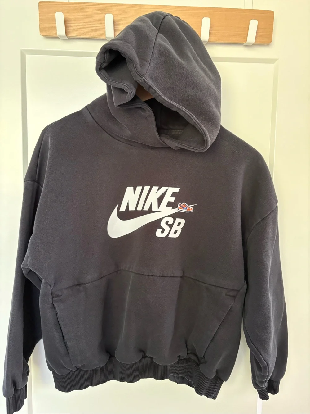 Nike SB Black Pullover Hoodie with White Swoosh, kids size Large.